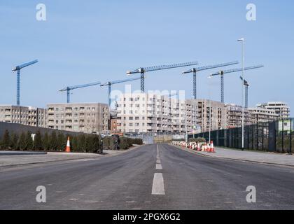 Vue de la route vide vers les nouveaux appartements en construction de Barking Riverside Housing Development, est de Londres, Angleterre, Royaume-Uni. Banque D'Images