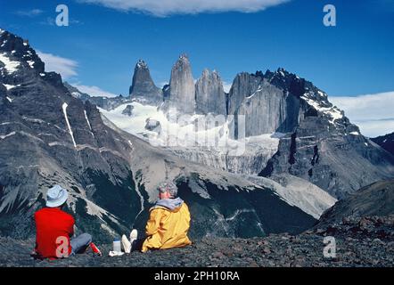 Chili. Parc national Torres del Paine. Scène de montagne avec deux hommes assis pour admirer la vue. Banque D'Images