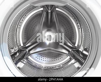 Gros plan du tambour du lave-linge. Arrière-plan du lave-linge. À l'intérieur du lave-linge. Tambour pour lave-linge en métal. Métal brillant perforé Banque D'Images