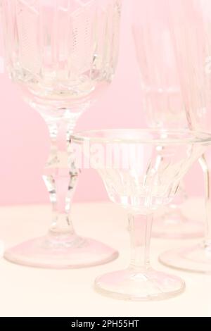 Verres en cristal sur fond rose. Composition vintage minimaliste. Banque D'Images