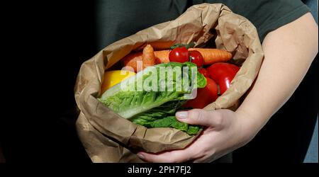 gros plan d'une femme tenant un sac de papier rempli de légumes. Concept de déchets organiques et zéro déchet Banque D'Images