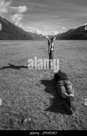 Touriste posant pour une photo à Eglinton Flats sur le chemin de Milford Sound, Parc national de Fiordland, South Island, Nouvelle-Zélande Banque D'Images