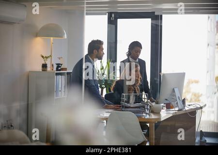 Cela permet de réussir quoi que ce soit. collègues travaillant ensemble sur un ordinateur dans un bureau. Banque D'Images