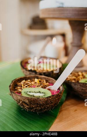 Une dose verticale de divers desserts, servis dans des coquilles de noix de coco Banque D'Images