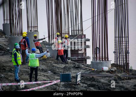 Guwahati, Inde. 27 mars 2023. Les ouvriers de la construction se sont occupés à fabriquer un poteau en béton près de la rivière Brahmaputra à Guwahati. Banque D'Images