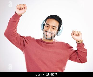 Casque, heureux et homme dansant dans un studio à la musique, liste de lecture ou album pour le divertissement. Bonheur, danse et modèle masculin indien se déplaçant à la Banque D'Images