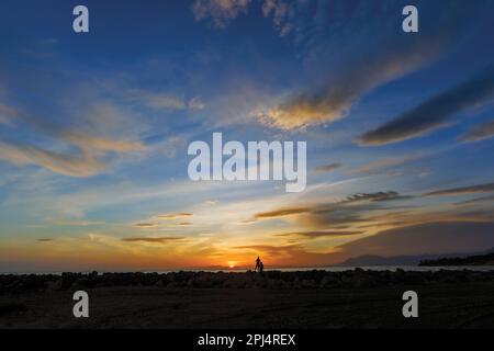 Deux personnes regardant le coucher du soleil près de Marbella, province de Malaga, Costa del sol, Andalousie, Espagne. Banque D'Images