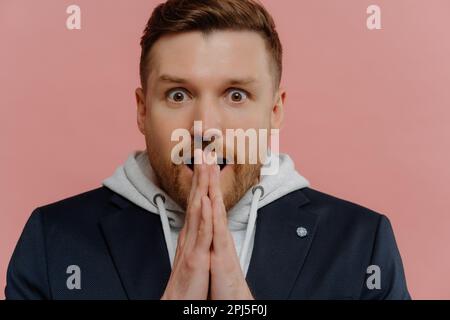 Un homme européen à barbe émotif surprend les palmiers ensemble pointe les yeux bugged les bâches de Wonder porte une veste noire à capuche isolée par-dessus la goupille Banque D'Images