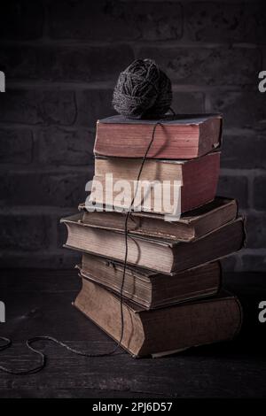 Pile de vieux livres avec boule de laine dans le style vintage Banque D'Images