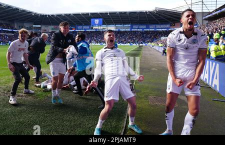 Liam Cullen (au centre) de Swansea City, Nathan Wood (à droite) et ses coéquipiers fêtent après que Ben Cabango (caché) ait terminé le troisième but du match du championnat Sky Bet au Cardiff City Stadium. Date de la photo: Samedi 1 avril 2023. Banque D'Images