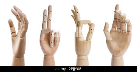 Placez les mains en bois de mannequins montrant différents gestes sur fond blanc. Bannière Banque D'Images