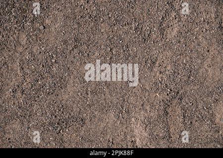Dark brown gravel background. Common city textures Banque D'Images