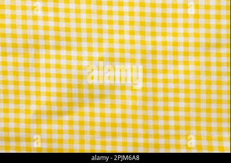 Texture de coton à carreaux jaune et blanc. Toile de fond textile Banque D'Images