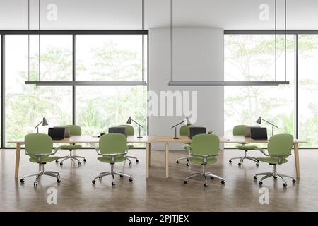 Intérieur de bureau blanc avec fauteuils verts et ordinateur portable sur une table commune en rangée, sol en béton beige. Espace de travail et fenêtre panoramique sur les tropiques. Banque D'Images