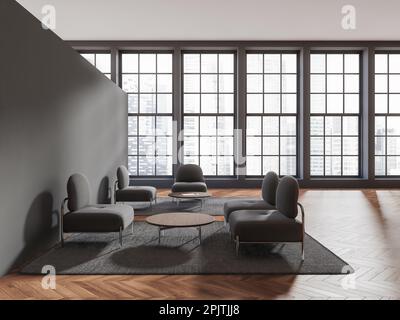 Intérieur d'une élégante salle d'attente de bureau avec murs gris, parquet, fauteuils gris confortables debout près de tables basses et fenêtres avec flou Banque D'Images