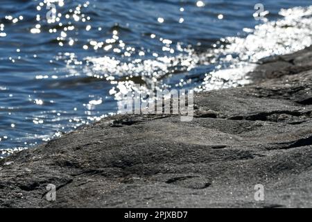 Effet d'ondulation sur l'île rocheuse de l'archipel en Finlande lors d'une journée ensoleillée d'été Banque D'Images