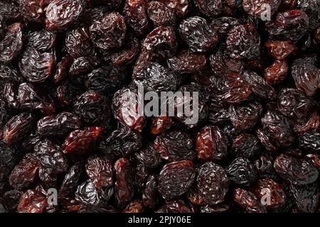 Les raisins secs flamme noirs du Chili plein cadre se rapprochent de l'arrière-plan Banque D'Images