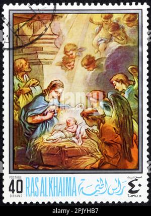 Ras AL-KHAIMAH - VERS 1968 : un timbre imprimé à Ras al-Khaimah montre la Nativité, peinture de Charles Andre van Loo (1705-1765), peintre français, vers 19 Banque D'Images