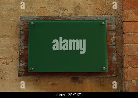 Panneau vert vierge fixé au mur de briques. Espace de conception Banque D'Images