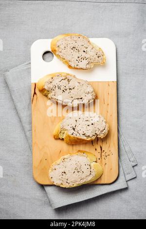 Baguette avec pâté de foie sur une nappe en lin. Banque D'Images