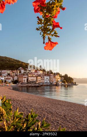 Beau lever de soleil le matin. Plage de sable dans la baie de Moö?eni?ka Draga avec vue sur le vieux centre-ville et le port. Région de vacances Istria, Croatie Banque D'Images