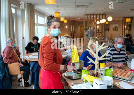 Atelier culinaire dans une résidence de service senior, animation, préparation et dégustation de biscuits au sirop d'érable. Banque D'Images