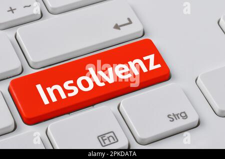 Un clavier avec un bouton rouge - insolvabilité en allemand - Insolvenz Banque D'Images