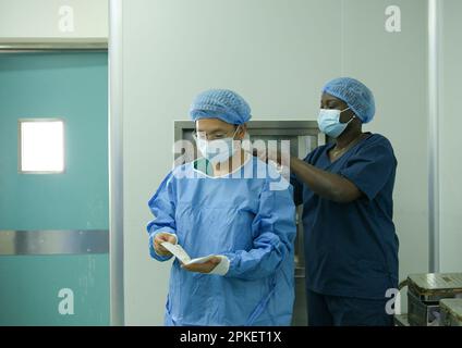 Dakar. 31st mars 2023. Zhang Yong (L), membre de l'équipe médicale chinoise, se prépare à la chirurgie à l'Hôpital pour enfants de Diamniadio à Dakar, au Sénégal, sur 21 mars 2023. Les 19th équipes médicales chinoises envoyées au Sénégal fournissent des services médicaux à l'hôpital pour enfants de Diamniadio depuis novembre 2021. Depuis 31 mars 2023, l'équipe médicale avait fourni 7 058 services de consultation externe, complété 3 150 chirurgies et 1 039 cas d'anesthésie. Credit: Han Xu/Xinhua/Alay Live News Banque D'Images