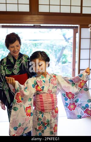 Fille s'habillée dans un yukata Banque D'Images