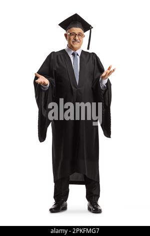 Portrait complet d'un homme mature dans une robe de graduation debout et gestante avec les mains isolées sur fond blanc Banque D'Images