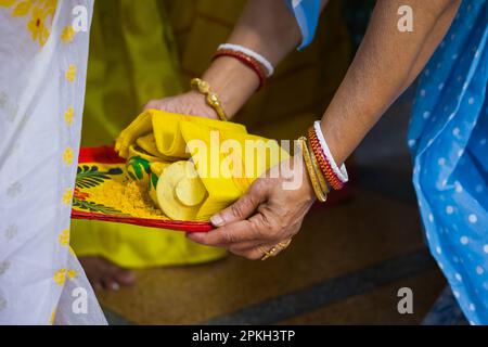 Varan ou le rituel de bore étant exécuté pendant le mariage hindou ou de la puja par la femme bengali traditionnelle portant le sankha. Le dala de bore est un kulo ou un bamb décoré Banque D'Images