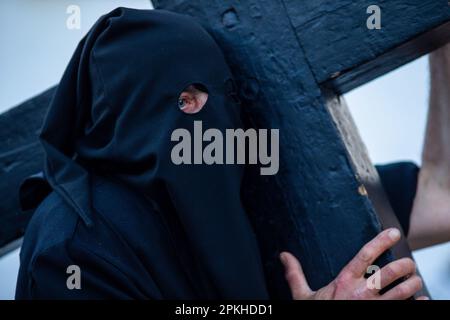 Sahagun, Espagne. 07th avril 2023. Un pénitent porte une croix en bois sur ses épaules, pendant la procession du Saint-Burial qui a traversé les rues de Sahagun. Crédit : SOPA Images Limited/Alamy Live News Banque D'Images