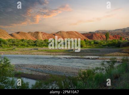 Collines colorées au bord de la rivière. Coucher de soleil sur la rivière Aras et les collines Rainbow. Frontière entre l'Arménie et la Turquie. Tuzluca, Igdir Banque D'Images