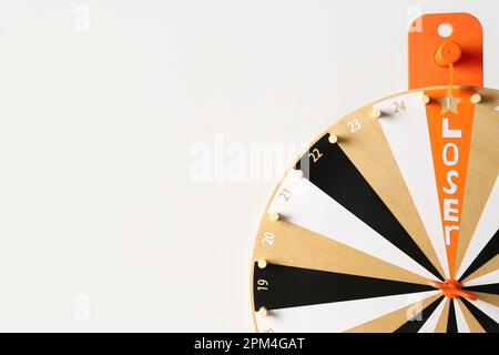 Roue qui tourne avec le mot PERDANT sur fond blanc, gros plan Banque D'Images
