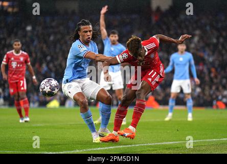 Manchester City's Nathan Aké, left, and Bayern Munich's Thomas Müller go  after the ball during the first half of a friendly soccer match Saturday,  July 23, 2022, at Lambeau Field in Green