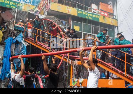 Dhaka, Bangladesh. 15th avril 2023. Les trois services militaires en uniforme du pays, l'armée de terre, la marine, l'armée de l'air et le bataillon d'action rapide, aident à éteindre un incendie au Nouveau supermarché de Dhaka. Un coup de feu massif a éviscéré les magasins du nouveau supermarché de Dhaka, l'un des plus grands marchés de l'habillement du pays, devant Eid-ul-Fitr. Des membres du personnel d'urgence de l'Armée de terre, de la Force aérienne, du bataillon d'action rapide, de la police du Bangladesh et des gardes-frontières du Bangladesh ont Uni leurs forces avec 28 unités du Service des incendies et de la Défense civile pour essayer de maîtriser les flammes samedi. Crédit : SOPA Images Limited/Alamy Live News Banque D'Images