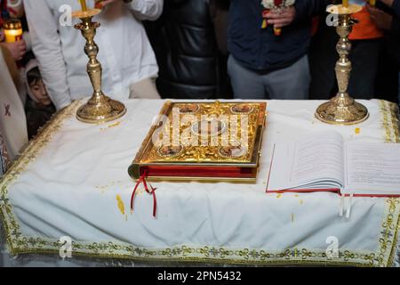 PR. Daniel officiant la cérémonie religieuse avec les fidèles qui aident dans le silence. Les fidèles de la paroisse de l'Annonciation, l'église fréquentée par les Roumains de la foi orthodoxe d'Ostia Lido, participent au rituel du feu sacré. Le rite du feu sacré, le samedi Saint des Églises qui suivent le calendrier Julien, au plus haut du Triduum de Pâques pour les fidèles orthodoxes du monde entier, A eu lieu de la même façon pendant au moins six siècles et date de l'Église de Constantine, au 4th siècle. C'est la suggestion de la flamme t Banque D'Images