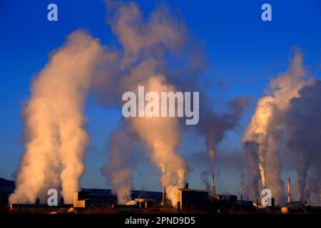 Les cheminées d'usine qui déversent la pollution dans le ciel fument des polluants qui augmentent dans l'air Banque D'Images