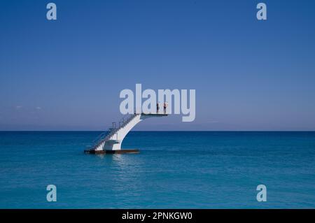 2 hommes debout sur une plate-forme de plongée dans la mer Banque D'Images