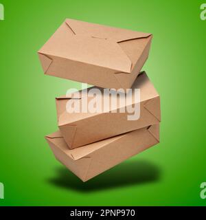 Boîte en carton vierge flottante pour les aliments prêts à consommer sur fond vert à gradient radial Banque D'Images