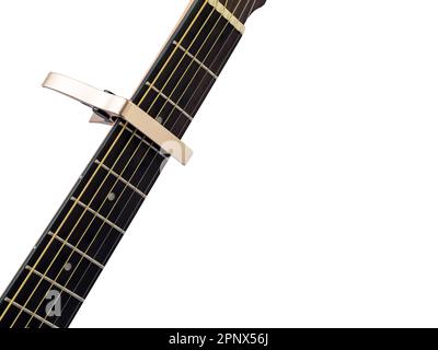 Gold capo sur le fingerboard de guitare, fond blanc, gros plan Banque D'Images