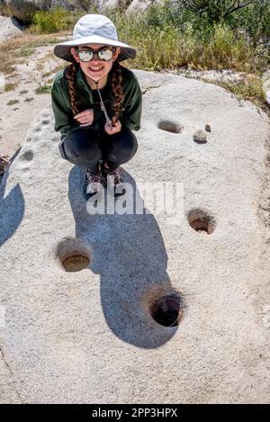 Une jeune fille regarde un Trésor archéologique de Kumeyaay dans la réserve culturelle de la vallée de Little Blair, parc national du désert d'Anza Borrego, CA Banque D'Images