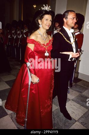 LA REINE SILVIA de Suède a soutenu son mari le roi Carl XVI Gustaf et avec une béquille après un accident de ski, en route pour dîner à Copenhague au Danemark Banque D'Images