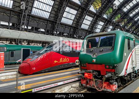 Un train Alstom AGV à grande vitesse Itlao à la gare centrale de Milan, à côté d'un Trenord classe E 464, un opérateur ferroviaire régional en Lombardie (Italie) Banque D'Images