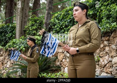 Jérusalem, Israël. 23rd avril 2023. Les soldats des FDI placent de petits drapeaux israéliens avec des rubans noirs sur chacune des tombes et saluent les morts au cimetière militaire du Mont-Herzl avant le jour du souvenir, Yom Hazikaron, pour les soldats israéliens tombés et les victimes d'attaques terroristes. Le Memorial Day sera célébré le 24th avril 2023. Crédit : NIR Amon/Alamy Live News Banque D'Images