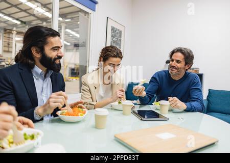 Des collègues heureux qui ont pris des repas ensemble dans l'industrie Banque D'Images