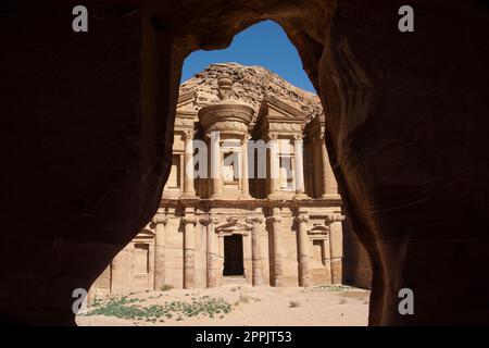 Vue sur le monastère, ad Deir, de la ville historique de Pétra, en Jordanie, vu de l'intérieur d'une grotte bédouine. Banque D'Images