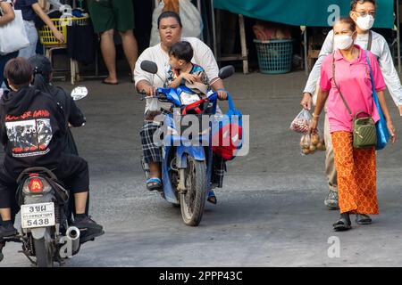 SAMUT PRAKAN, THAÏLANDE, APR 07 2023, Une femme prend un petit garçon sur une moto parmi les gens Banque D'Images