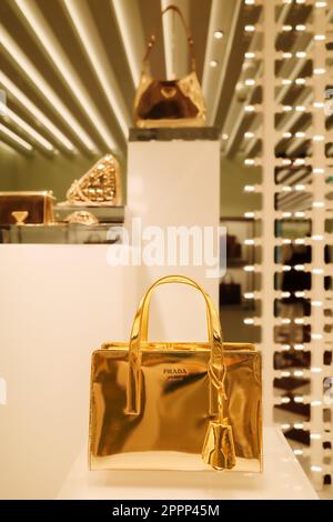 Zurich, Suisse - 15 décembre 2022 : un luxueux sac à main Prada doré dans une fenêtre de boutique Banque D'Images