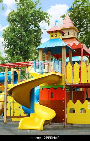 Nouvelle maison de jeu de château colorée avec toboggan sur l'aire de jeux pour enfants Banque D'Images